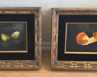 Pair of classical European-style still life paintings in decorative frames.
