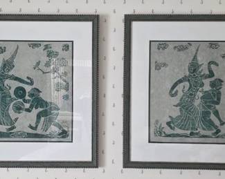 A pair of framed, matted green-toned Thai temple rubbings.