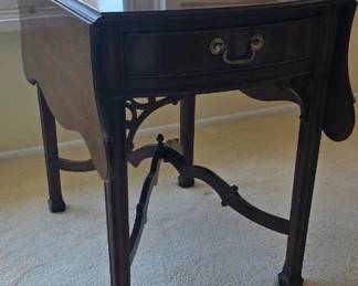 Vintage mahogany drop-leaf table in the Chippendale style.
