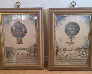 A pair of framed, hand-colored etchings of hot air balloons by artist Charles Dupont.