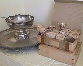 A silver-plated three-piece demitasse set consisting of a scalloped tray with matching ladle and 24 cups.