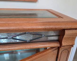 #71	Oak Entry Cabinet w/2 glass doors and 1 Glass Shelf w/leaded Décor accents w/glass Beveled Top w/light from Bottom Shelf w/ Matching Wood Mirror - 34x14x30  Mirror - 23x46	 $125.00 