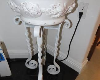 Iron stand with large ceramic bowl.