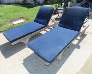 Two weathered teak sun loungers and cushions.
