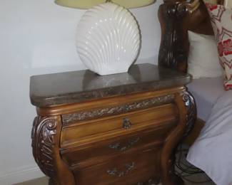 One of two marble top nightstands.