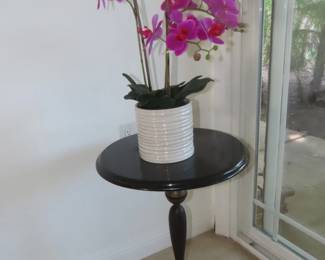 Iron pedestal stool and fake orchid.