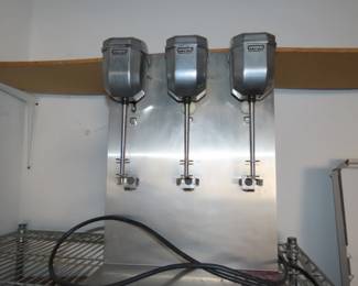 Commercial smoothie/milkshake bleanders with multiple mixing cups.