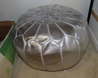 Silver colored poufee.