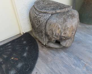 One of two large carved wood elephant end tables.