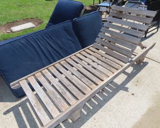 Two weathered teak sun loungers and cushions.