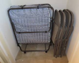 Folding spare bed and chairs.