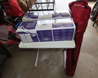 two brand new folding chairs.