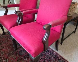 Pair of red upholstered arm chairs