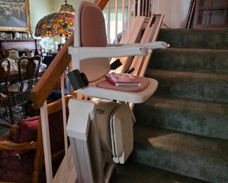 Mobility aides, including this power stairlift for switchback staircase