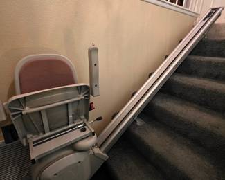 Mobility aides, including this power stairlift for switchback staircase