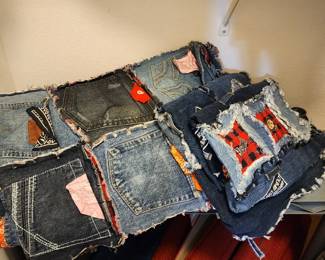 Totally unique, hand mad king size quilt with pillow shams custom made from jean pockets with various patches and symbols