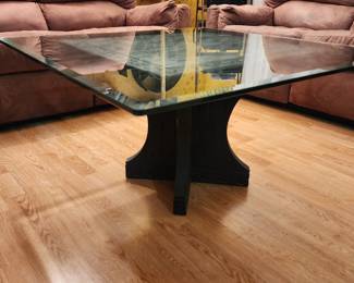 Glass top, carved wood base coffee table