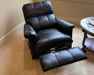 R28 -$150. Black Rocking Recliner from La-Z-Boy. Measures 34" wide x 38" tall.  Rocks until you put the foot rest out and then it locks for a nap! Soft leather - very gently used. Headrest is not stained. 