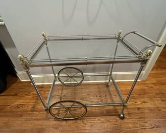 R82 - $450. French Bar Cart. Brass & Glass with finials. Rolls easily! Measures 36" x 20" x 33" tall. 