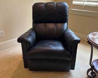 R28 -$150. Black Rocking Recliner from La-Z-Boy. Measures 34" wide x 38" tall.  Rocks until you put the foot rest out and then it locks for a nap! Soft leather - very gently used. Headrest is not stained. 
