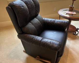 R28 -$150. Black Rocking Recliner from La-Z-Boy. Measures 34" wide x 38" tall.  Rocks until you put the foot rest out and then it locks for a nap! Soft leather - very gently used. Headrest is not stained. 