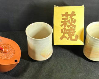 Lot 414: Yixing-style brown teapot with two cups and yellow box