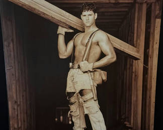 Lot 316: Man in distressed workwear with suspenders carrying a wooden beam