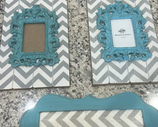 Lot 57: Teal ornate picture frames on chevron boards