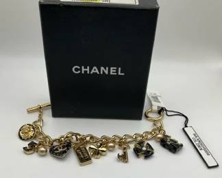 Chanel Gold Tone Charm Bracelet with CC Logo Clover Key Handbag and Pearl Accents