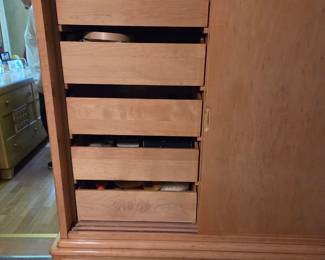 Baby dresser has 2 large bottom drawers and two sliding doors with small sliding drawers on top