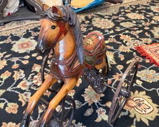 vintage folk art horse tricycle with wood body and saddle with iron wheels