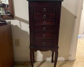 D24 - $40. Queen Anne style wooden jewelry box. Cherry finish. Measures 15.75” wide x 12” deep x 40” tall.  Some light scratches but overall good condition. Felt in the bottom two drawers is peeling, but easily repairable.