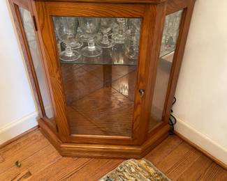 D2 - $150. Giuseppe Arcase English Oak Corner Curio Cabinet. Lighted. Measures 32” w 23” d 73” t. 