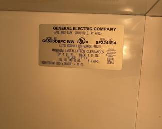 D33 - $100. GE Side by Side refrigerator/freezer. Works. Kept in garage. 
