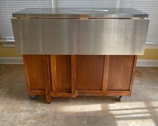 D16 - $150. Home Styles Rolling Kitchen Cart with storage and a drop leaf. Measures 43” wide x 20” deep x 35” tall. 30” deep with extension up.  Needs a little cleaning but very good condition!