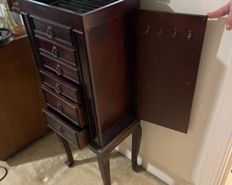 D24 - $40. Queen Anne style wooden jewelry box. Cherry finish. Measures 15.75” wide x 12” deep x 40” tall.  Some light scratches but overall good condition. Felt in the bottom two drawers is peeling, but easily repairable.