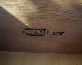 D25 - $400. Stanley bedroom set. Queen size bed, side table, tall, dresser, short dresser with two wall hanging mirrors. Bedside table measures 25” wide x 16” deep x 21.75” tall. Top is worn. Veneer chipped on the bottom.  Tall dresser measures 36” wide x 18.5” deep x 54” tall. Four drawers and three cubbies. Wear on doors from use.  Queen size headboard 49” tall. Mattress was used with a cover on it. Frame is on wheels. Frame is attached to the headboard. Long dresser measures 74” wide x 18.5” deep x 29.5 inches tall. Nine drawers. Some wear and veneer chipped off. Solid construction. Two mirrors measure 19“ wide x 45“ tall. 