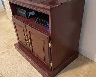 D9 - $35. Pressboard tv stand. Measures 24” wide x 19” deep x 28” tall. 