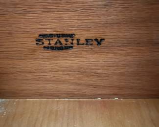 D25 - $400. Stanley bedroom set. Queen size bed, side table, tall, dresser, short dresser with two wall hanging mirrors. Bedside table measures 25” wide x 16” deep x 21.75” tall. Top is worn. Veneer chipped on the bottom.  Tall dresser measures 36” wide x 18.5” deep x 54” tall. Four drawers and three cubbies. Wear on doors from use.  Queen size headboard 49” tall. Mattress was used with a cover on it. Frame is on wheels. Frame is attached to the headboard. Long dresser measures 74” wide x 18.5” deep x 29.5 inches tall. Nine drawers. Some wear and veneer chipped off. Solid construction. Two mirrors measure 19“ wide x 45“ tall. 