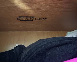 D25 - $400. Stanley bedroom set. Queen size bed, side table, tall, dresser, short dresser with two wall hanging mirrors. Bedside table measures 25” wide x 16” deep x 21.75” tall. Top is worn. Veneer chipped on the bottom.  Tall dresser measures 36” wide x 18.5” deep x 54” tall. Four drawers and three cubbies. Wear on doors from use.  Queen size headboard 49” tall. Mattress was used with a cover on it. Frame is on wheels. Frame is attached to the headboard. Long dresser measures 74” wide x 18.5” deep x 29.5 inches tall. Nine drawers. Some wear and veneer chipped off. Solid construction. Two mirrors measure 19“ wide x 45“ tall. 