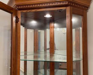 D2 - $150. Giuseppe Arcase English Oak Corner Curio Cabinet. Lighted. Measures 32” w 23” d 73” t. 