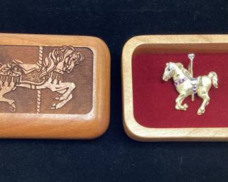 14k, ruby, saphire, diamond pendant 3.6 grams This 14k gold two tone carousel horse features pendant hook and brooch pin with satin and polished gold. Comes with music gift box