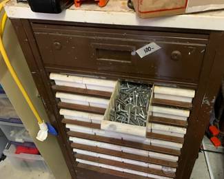 #86	Metal Cabinet on wheels 28 drawers w contents 21x18x41"	 $100.00 			