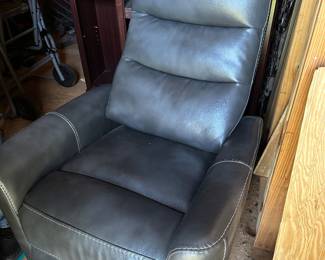 Fantastic brand new recliner. Swivels.. Faux leather. Grey.