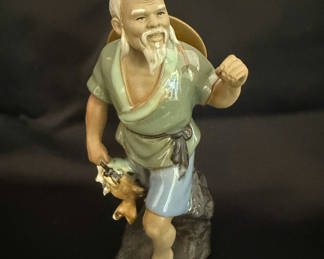Lot 36: Vintage Shiwan Mudman figurine depicting a fisherman holding a fish.