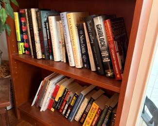 Wooden bookcase with assorted books