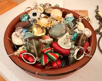 Assorted earrings and pendants in bowl