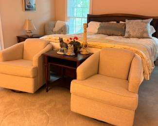 Bedroom with pair of upholstered swivel chairs