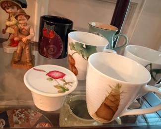 Assorted decorative mugs and Hummel figurine