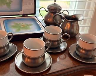 Pewter teacup and saucer set with teapot